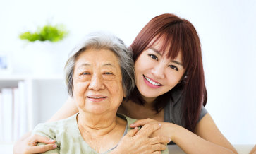 caregiver and her daughter smiling